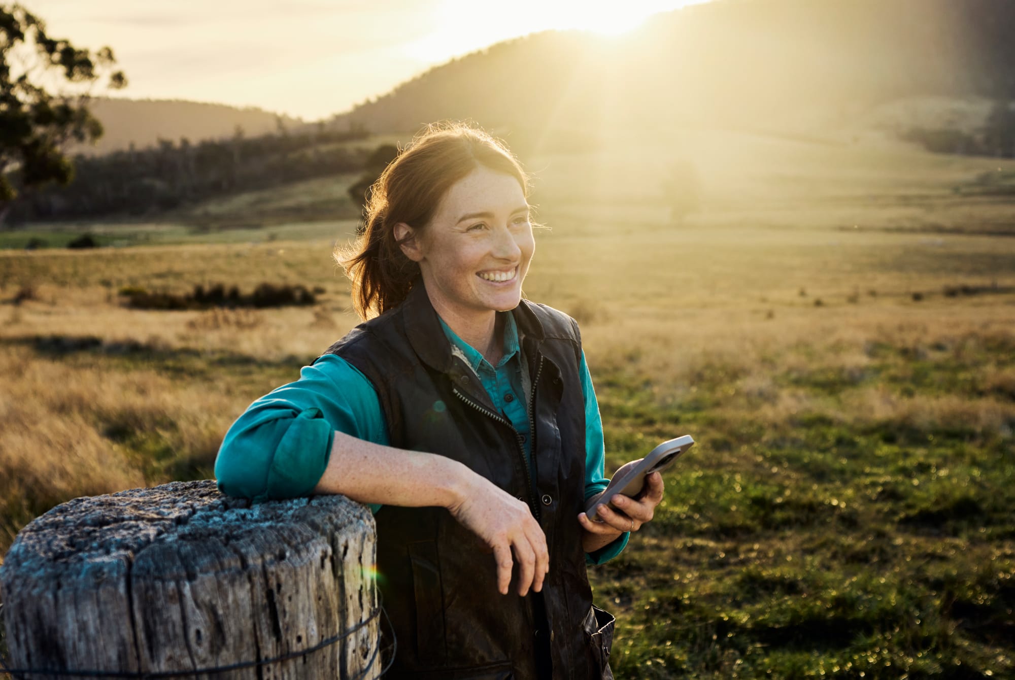 Woman looking at her phone on a farm.